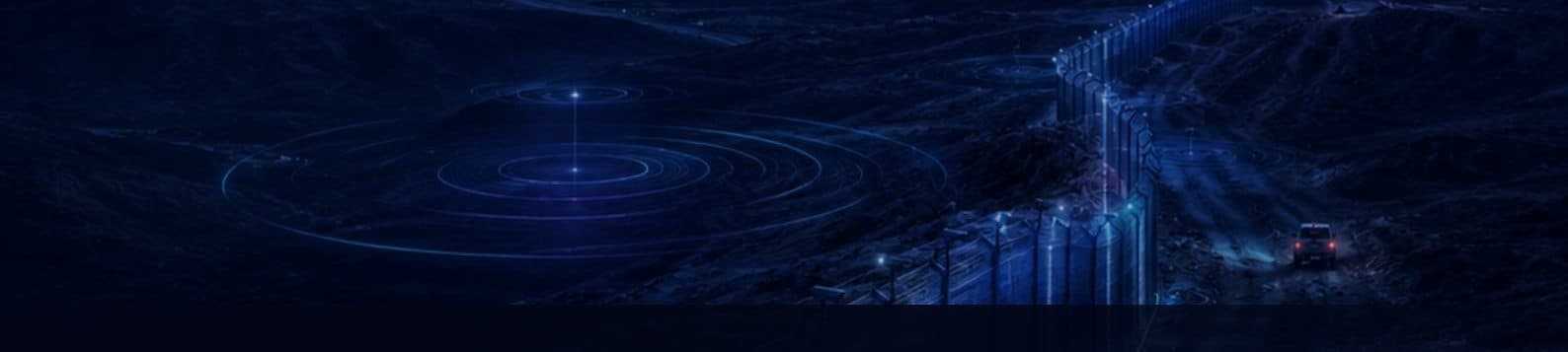 A sensing fence line at night with acoustic detection rings along the perimeter